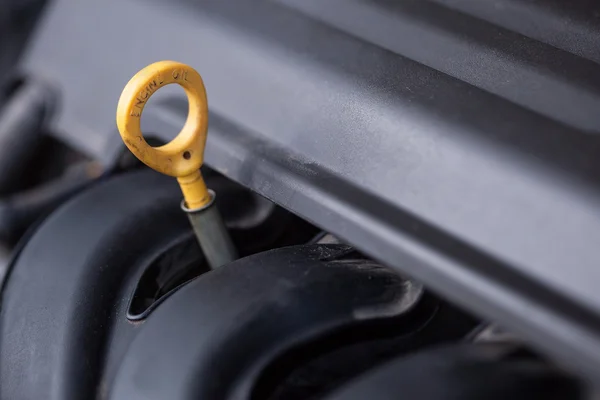 Yellow oil dipstick in the car