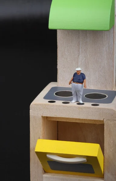 Miniature figurine of an obese man over the stoves of a kitchen