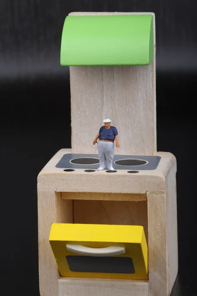 Miniature figurine of an obese man over the stoves of a kitchen