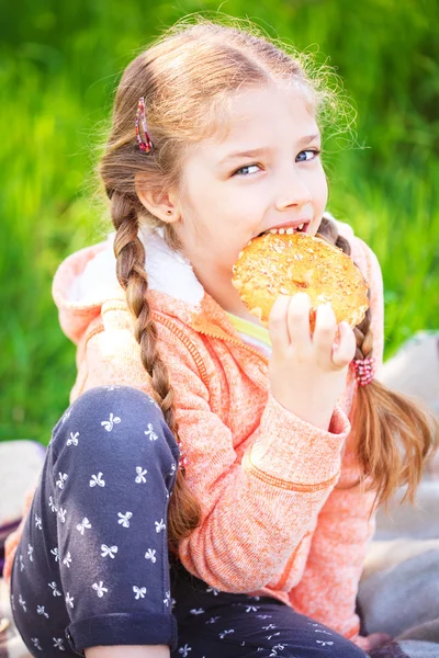 Little cute girl eating cookies