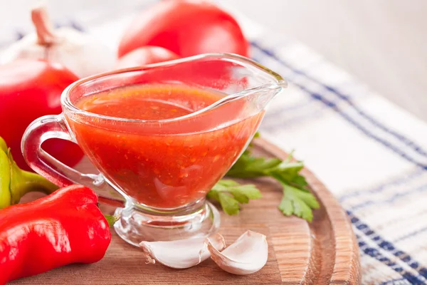 Tomato sauce in a glass gravy boat