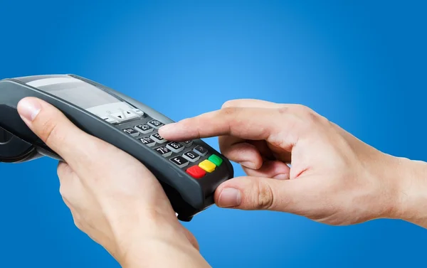 Hand with credit card swipe through terminal for sale