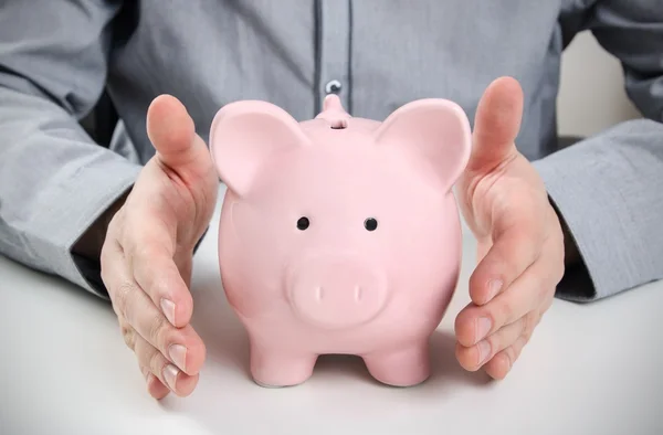 Business man with piggy bank. Saving money concept