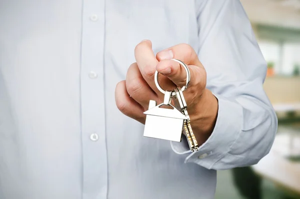 Estate agent holding keys to new house