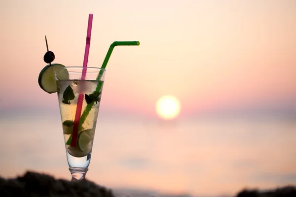 Mojito cocktail on the beach at sunset