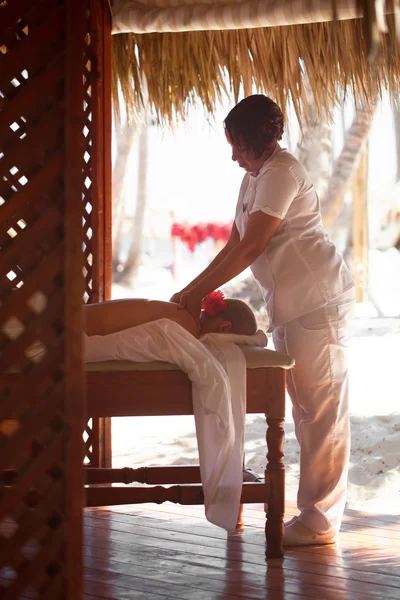 Woman giving a female customer body massage
