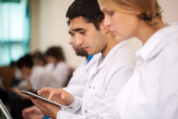 Medical student working with pad on the conference