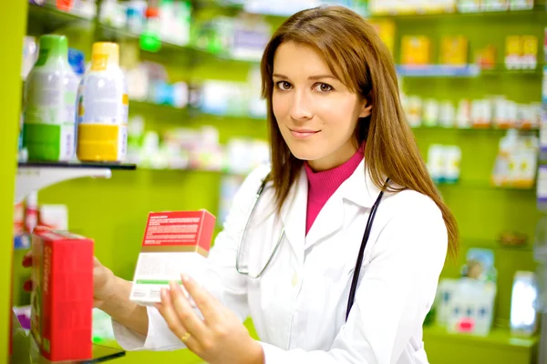 Smiling female pharmacist at work