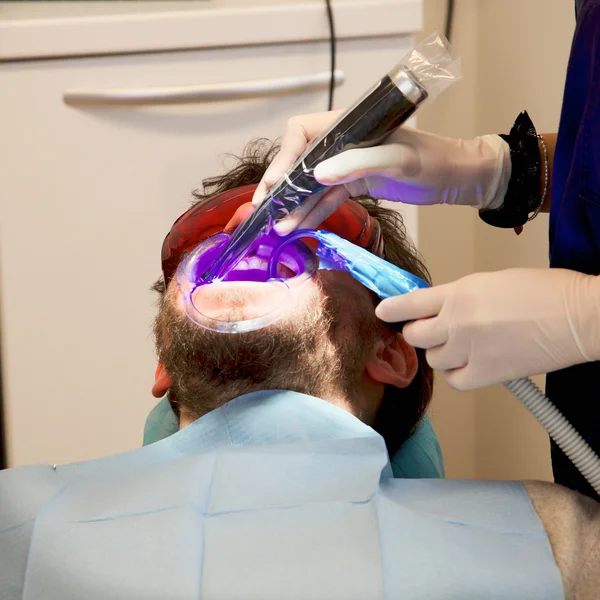 Man getting dental surgery and laser treatment