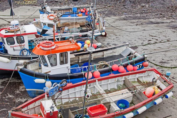 Fishing fleet aground in a Cornish harbour