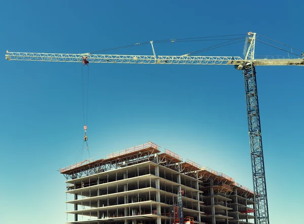 Massive crane assists in construction of high rise development.