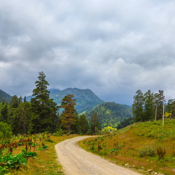 Mountain landscape, ground road through mountain valley
