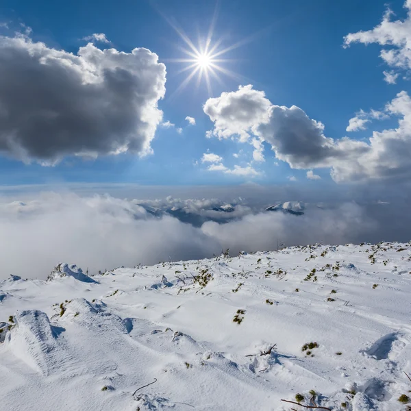 Winter mountain slope under a sparkle sun