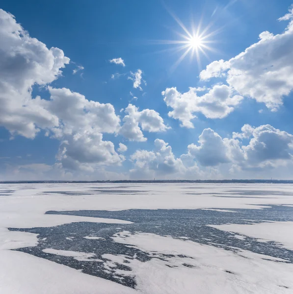 Frozen winter river under a sparkle sun