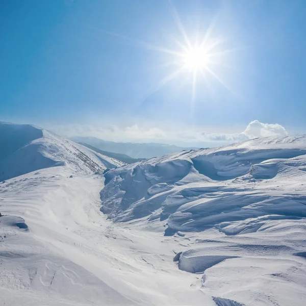 Winter snowbound hills under a sparkle sun