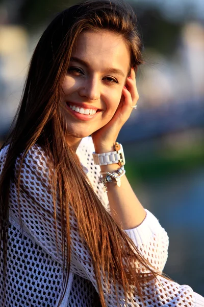 Portrait Of Young Smiling Beautiful Woman. Close-up portrait of a fresh and beautiful young fashion model posing outdoor.