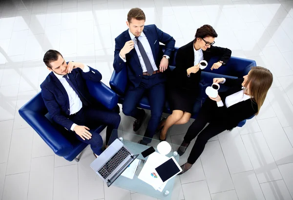 Top view of working business group sitting at table during meeting