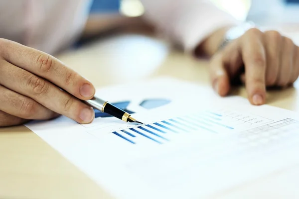 Business adviser analyzing financial figures denoting the progress in the work of company