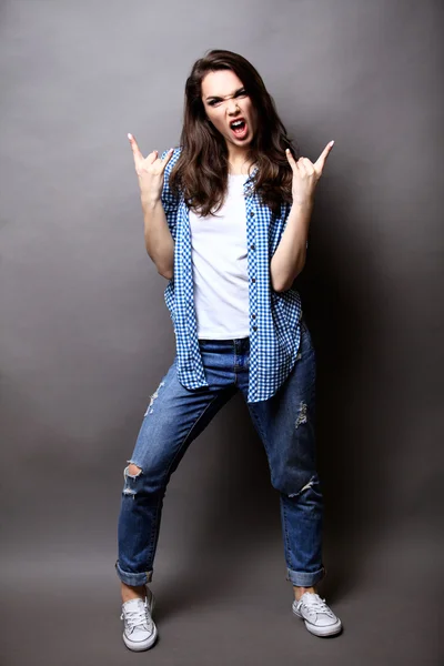 Winner woman celebrating success Isolated on grey background.