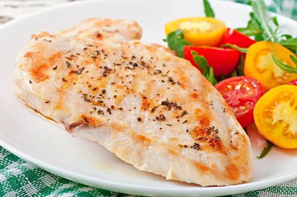 Grilled chicken breasts and fresh salad