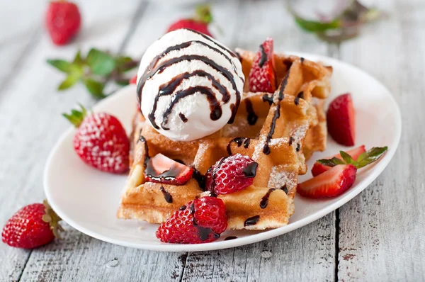 Waffles with  strawberries and ice cream