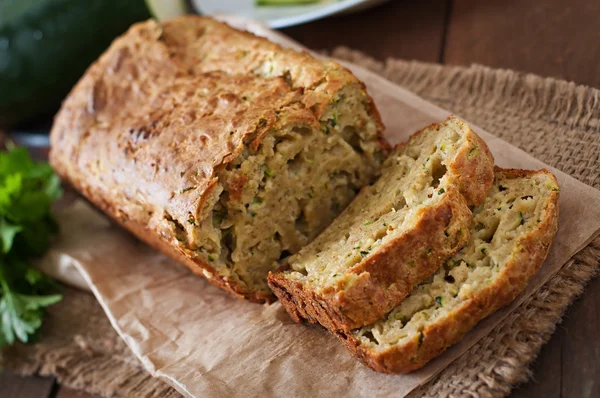 Zucchini bread with cheese on a wooden background