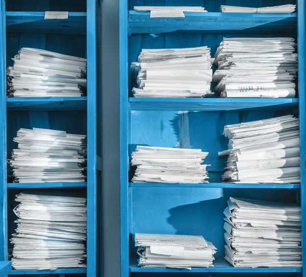 Paper documents stacked in archive