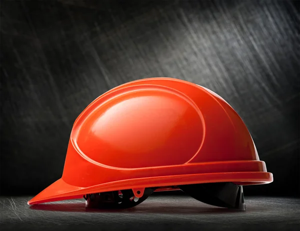 Red safety helmet on steel