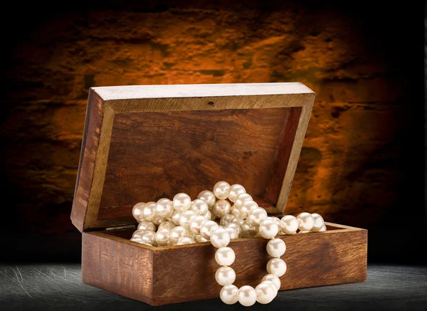Chest with white pearl necklace