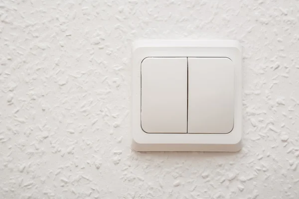 Power switch on white wall