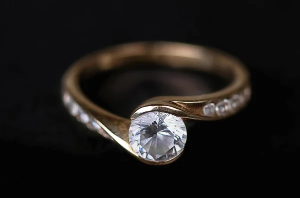 Gold ring on a black background.