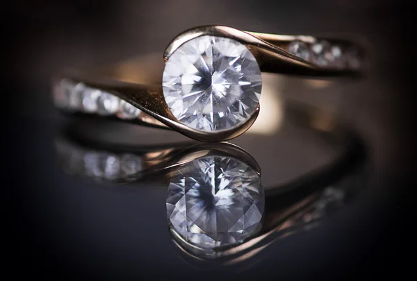 Wedding ring with diamonds on a black background.