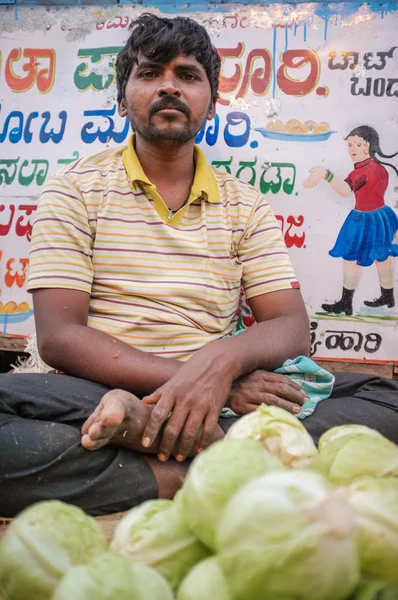 Indian man selling vegetables