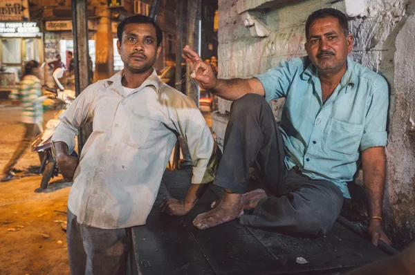 Indian men relax on street