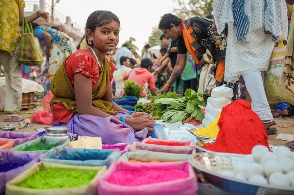 Indian girl selling colored powder