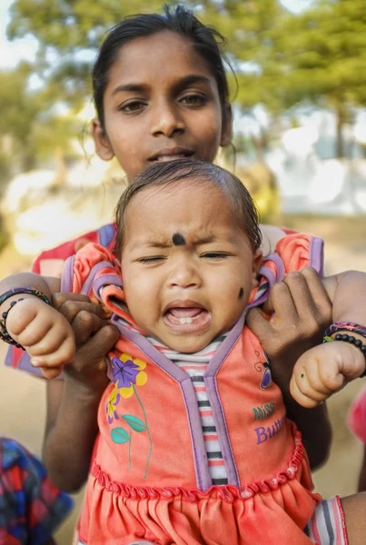 Indian baby being held by family member
