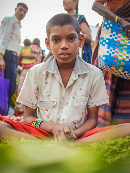 Young indian vendor selling vegetables