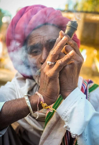 Rabari tribesman smokes