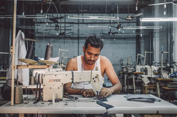 Indian worker sowing