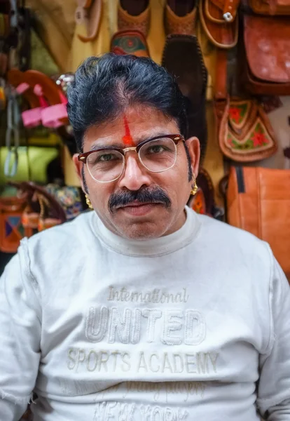 Owner with mustache wearing glasses