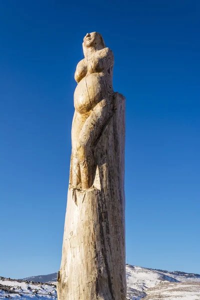 Wooden sculpture of a pregnant woman