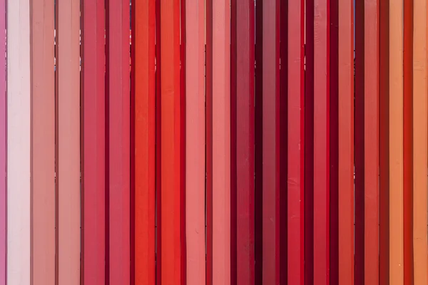 Wooden fence colored in shades of red