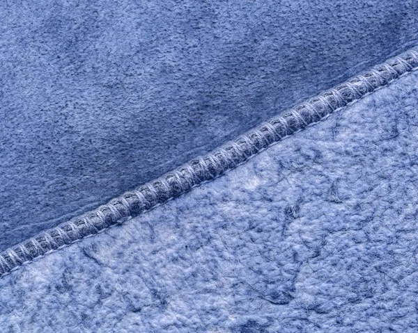 fragment of blue wrong side of sheepskin coat closeup