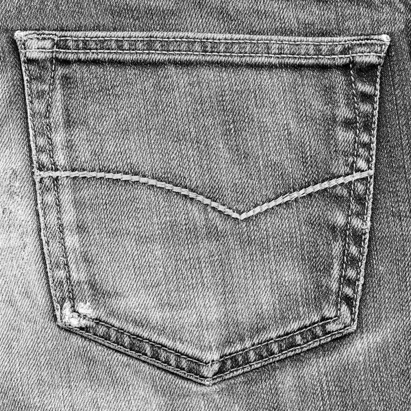 Gray jeans pocket closeup on jeans background
