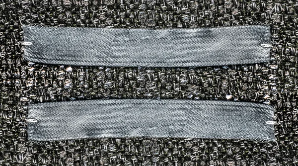 Gray-blue textile labels on gray textile background