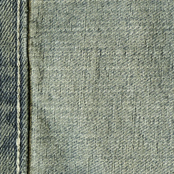 Texture of old blue jeans wrong side, seam