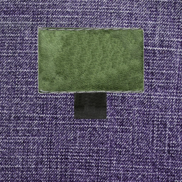 Violet denim texture, blank leather label