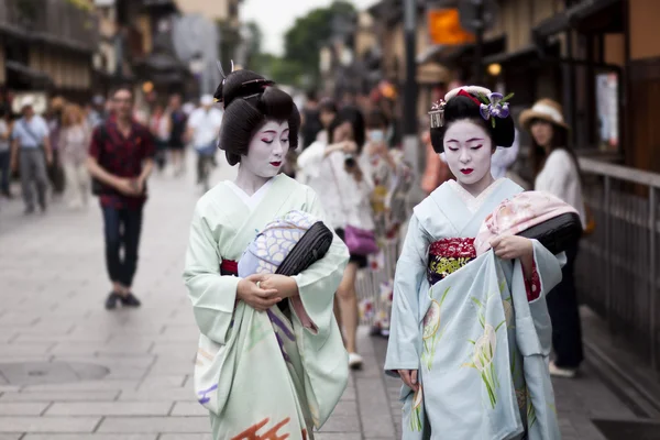 KYOTO, JAPAN - MAY 26,2016: Maiko in kimono performs in Gion district on May 26, 2016 in Kyoto, Japan. Maiko is a geisha apprentice, left from the medieval times.