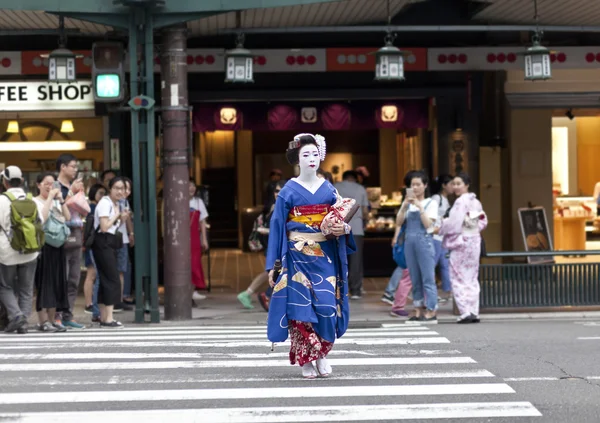 KYOTO, JAPAN - MAY 26,2016: Maiko in kimono performs in Gion district on May 26, 2016 in Kyoto, Japan. Maiko is a geisha apprentice, left from the medieval times.