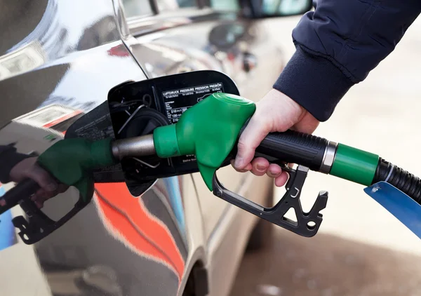 Man filling up car with fuel at petrol station